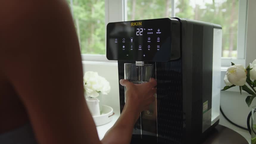 A person preparing a beverage using an espresso machine at home