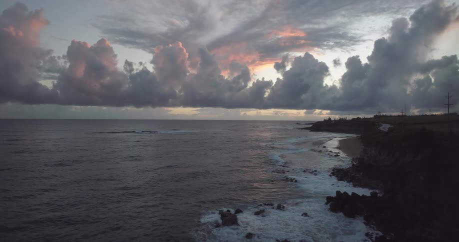 The sun is setting above the ocean water
