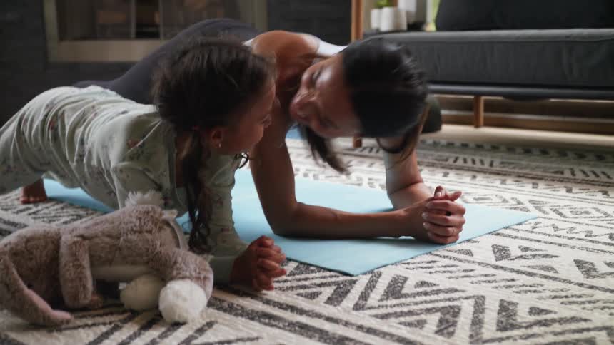 A woman and child do yoga together