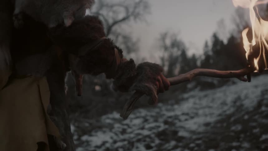 A man carries a torch in a snowy area