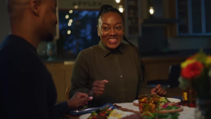 A man puts his phone down to eat dinner at home