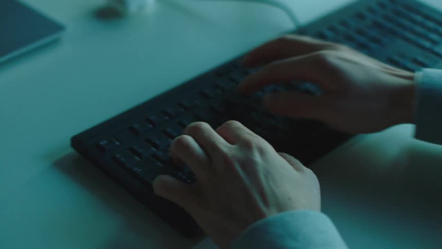 A person is typing on their keyboard
