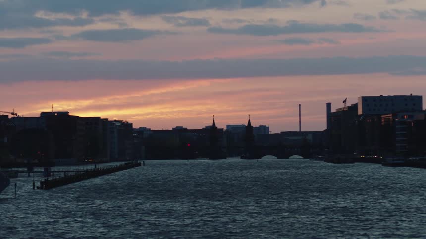 Molecule man sculpture on the spree river in berlin at sunset