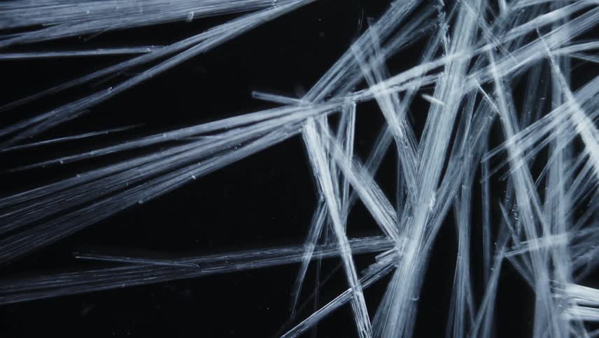 Light shines on strands of organic fiber in the darkness