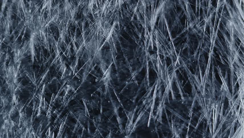 Crystalline icy shards form densely on black background