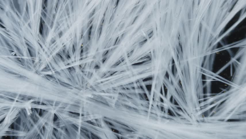 Ice crystals form against speckled background