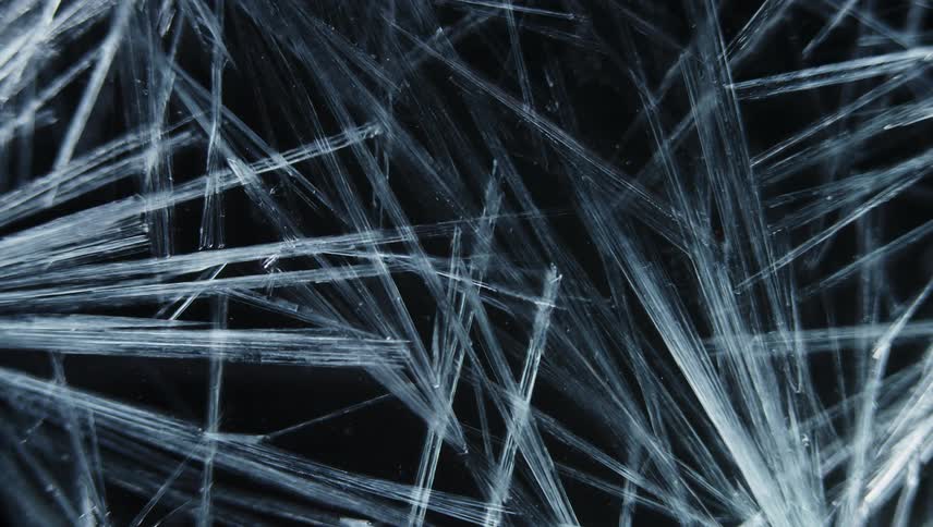 Light shines on strands of organic fiber in the darkness