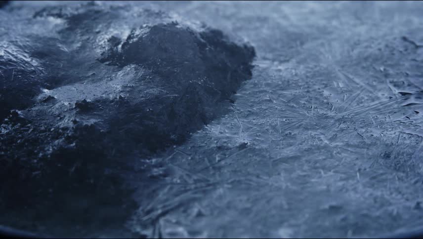 Extreme close up of frozen surfaced covered in long thin ice crystals