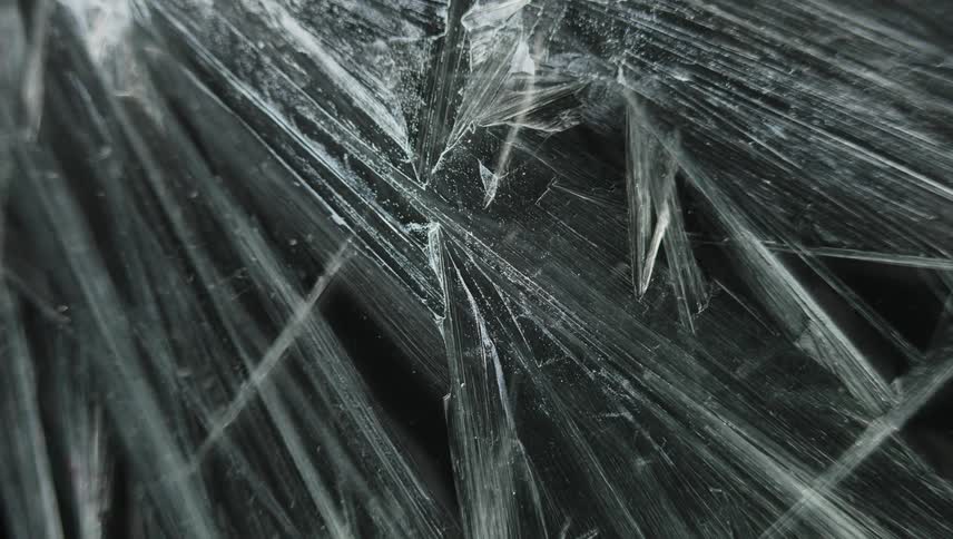Time lapse close up of of sharp thin ice crystals forming
