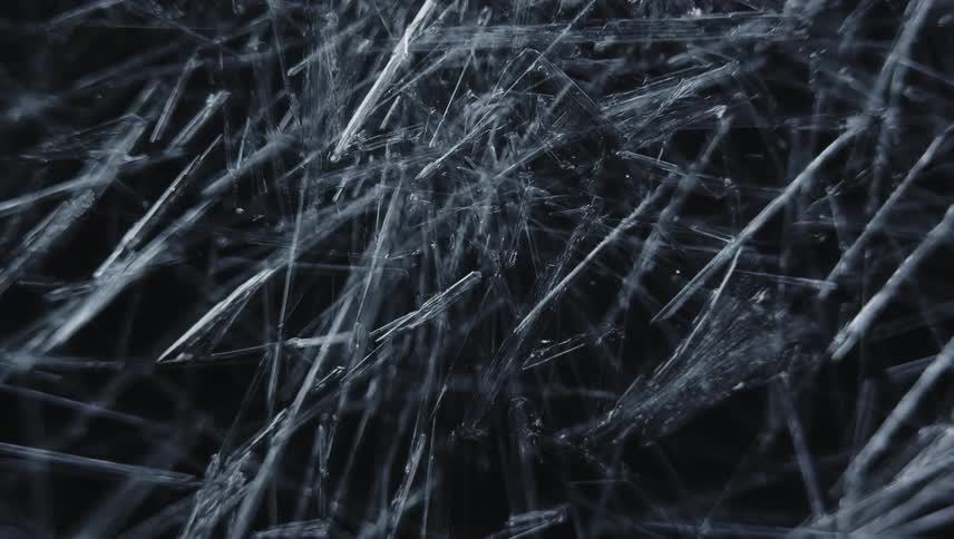Time lapse close up of of sharp thin ice crystals forming
