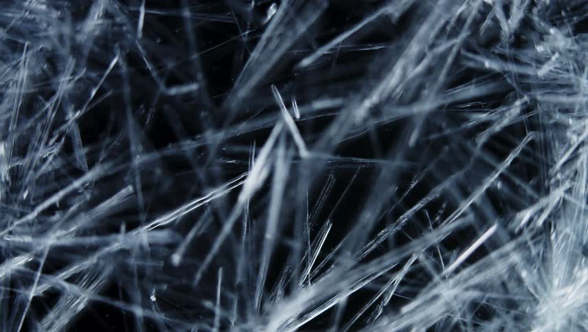 Time lapse close up of of sharp thin ice crystals forming