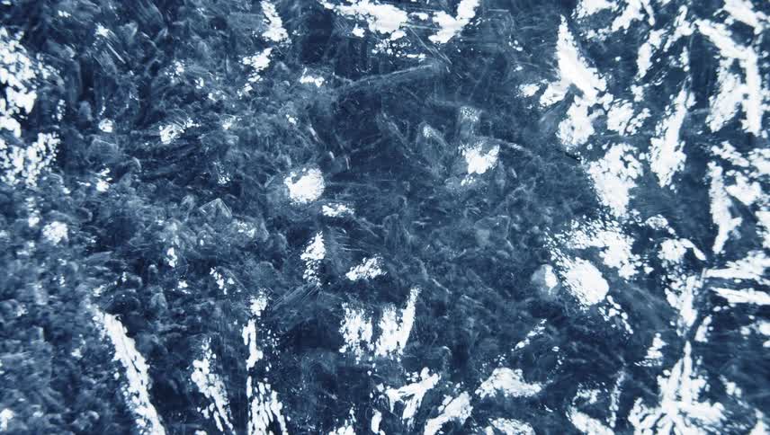 Frost forms spreading as white against blue background