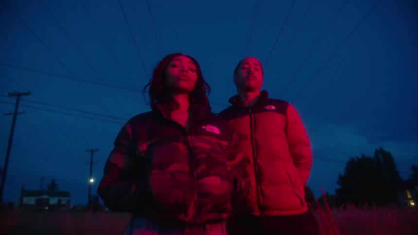 A man and woman are standing under the power lines