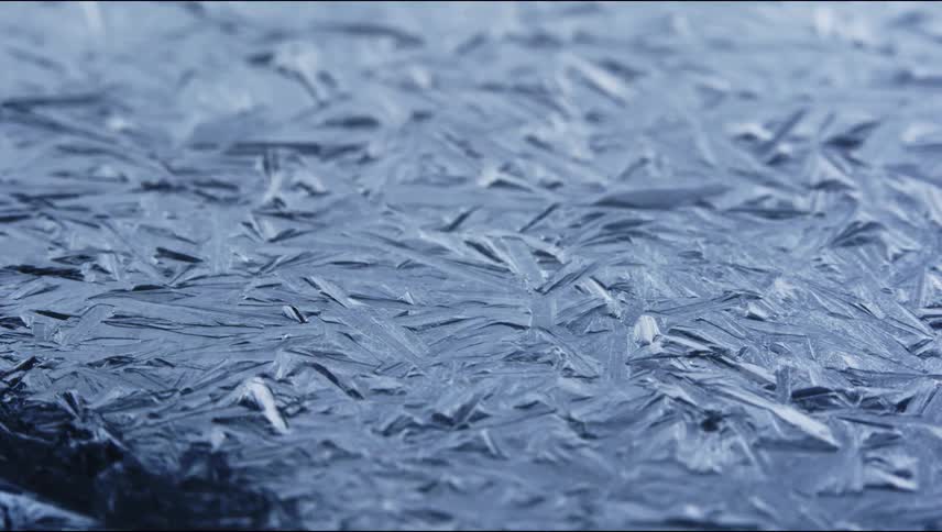 Close up of ice crystals forming over a wet surface