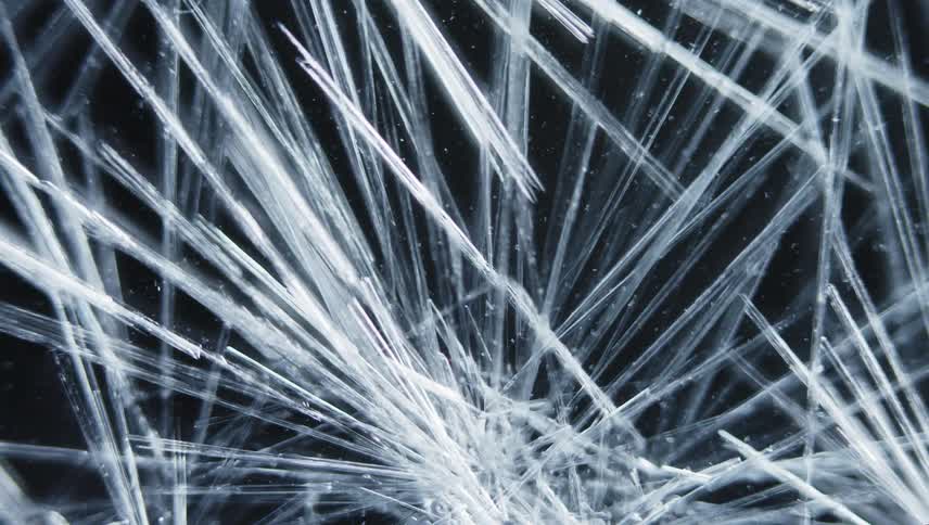 Icy crystalline shards grow densely on black background