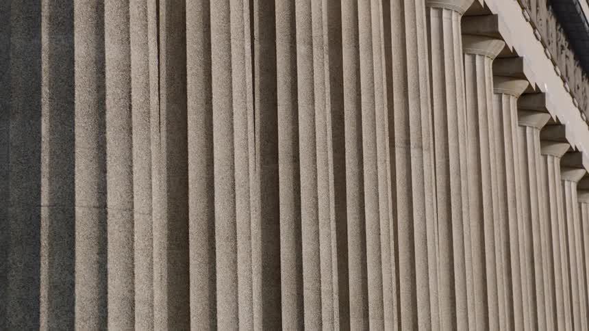 A row of marble columns holding up a capital
