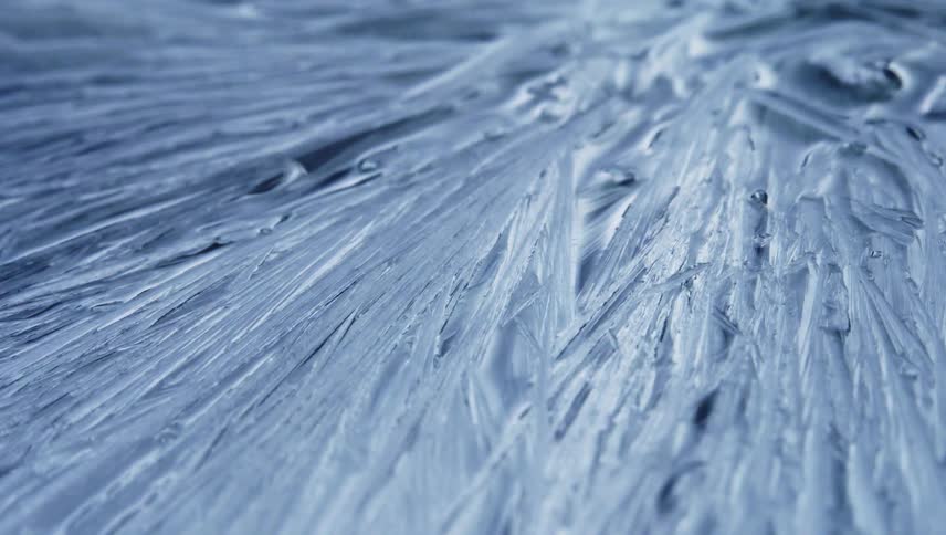 Ice crystals spread to cover dark surface