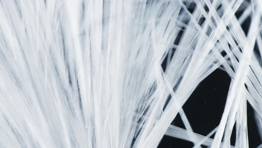 White pointed shards of crystal stretch against a black background