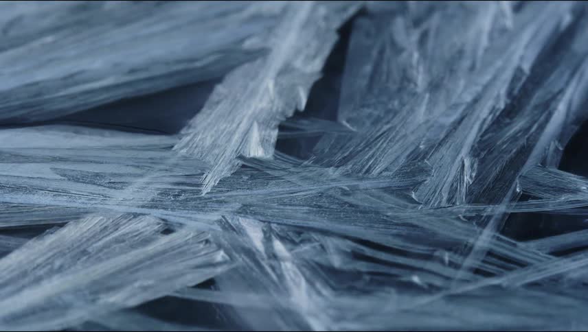 Time lapse close up of of sharp thin ice crystals forming