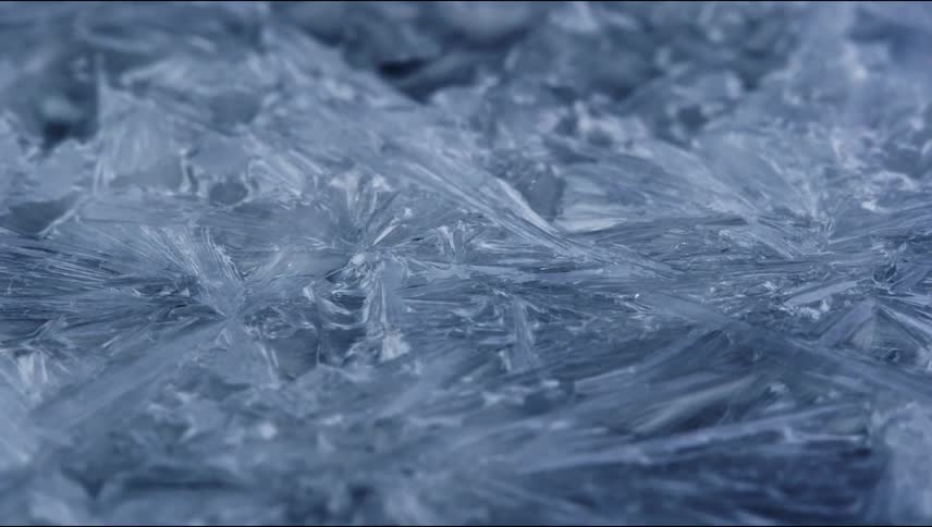 Extreme close up of frozen surfaced covered in long thin ice crystals