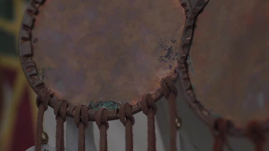 Leather circles with cords hanging from them