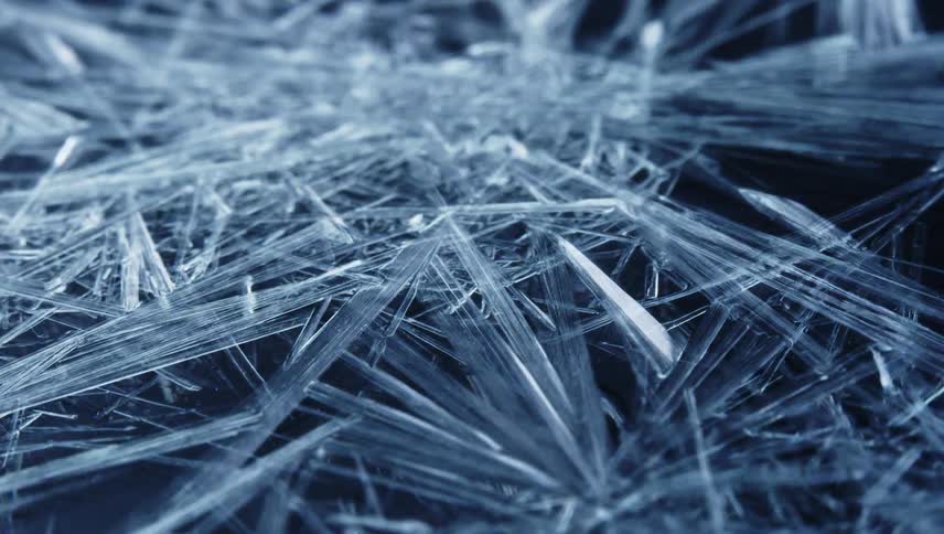 Icy crystalline shards form to cover black surface
