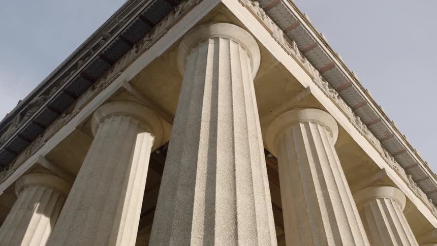 Marble columns and a capital standing out against a blue sky