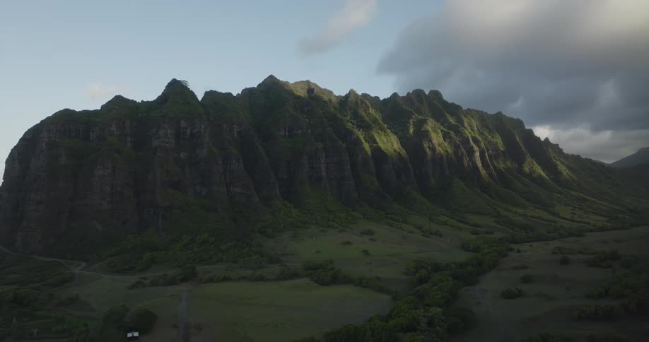 A view of a mountain with trees at the base