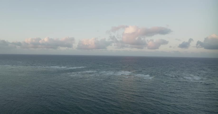 The open ocean under a blue daytime sky