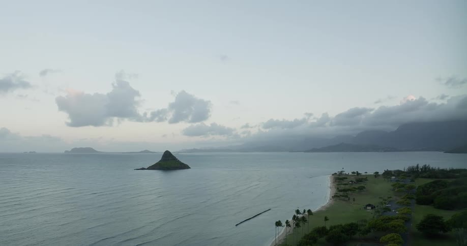 Aerial view of shoreline and small island at dusk