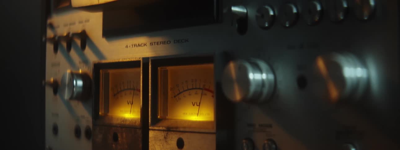 Lights glow and needles move on an old stereo system