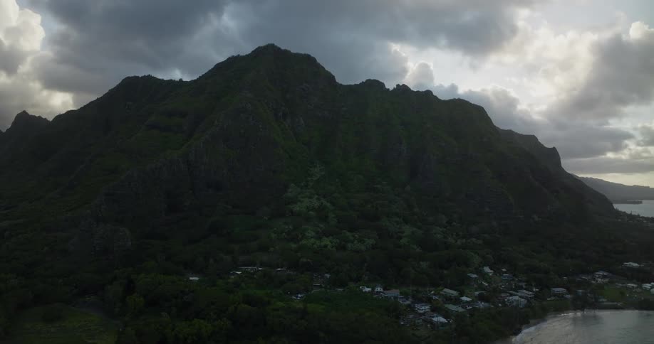 Aerial view of mountain and village next to lake