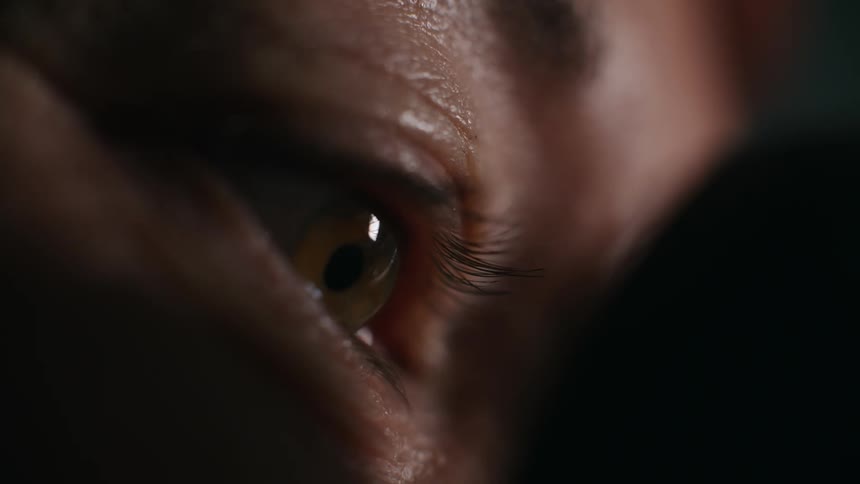 Close up of womans eye looking through camera lens