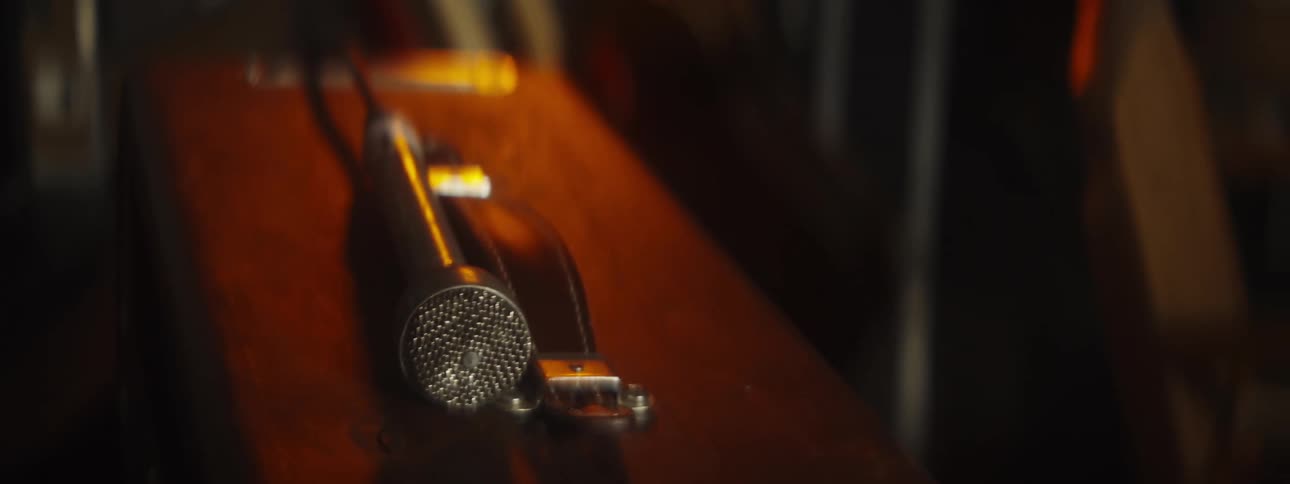 A retro microphone is sitting on a case with a handle