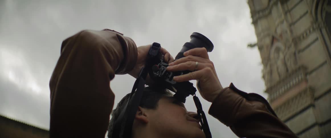 A man with a camera outdoors