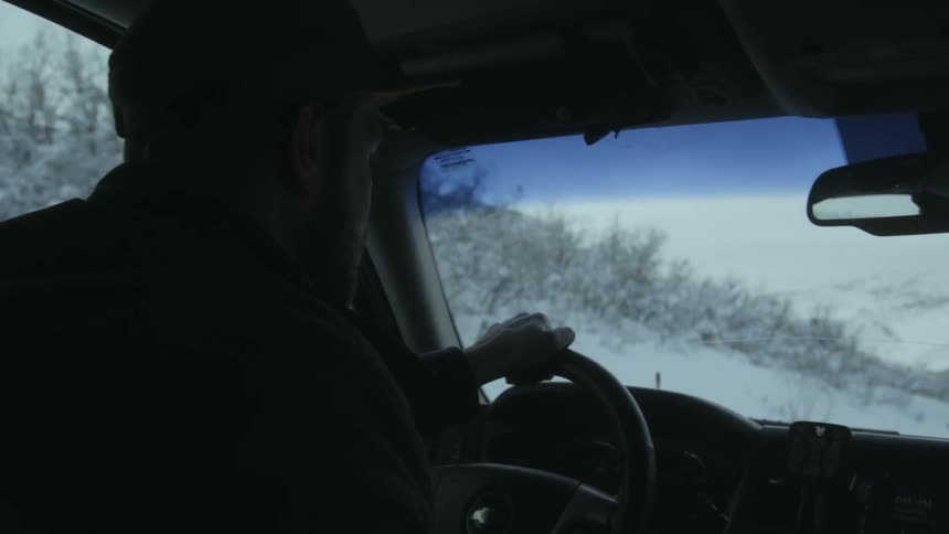A man driving a vehicle outdoors