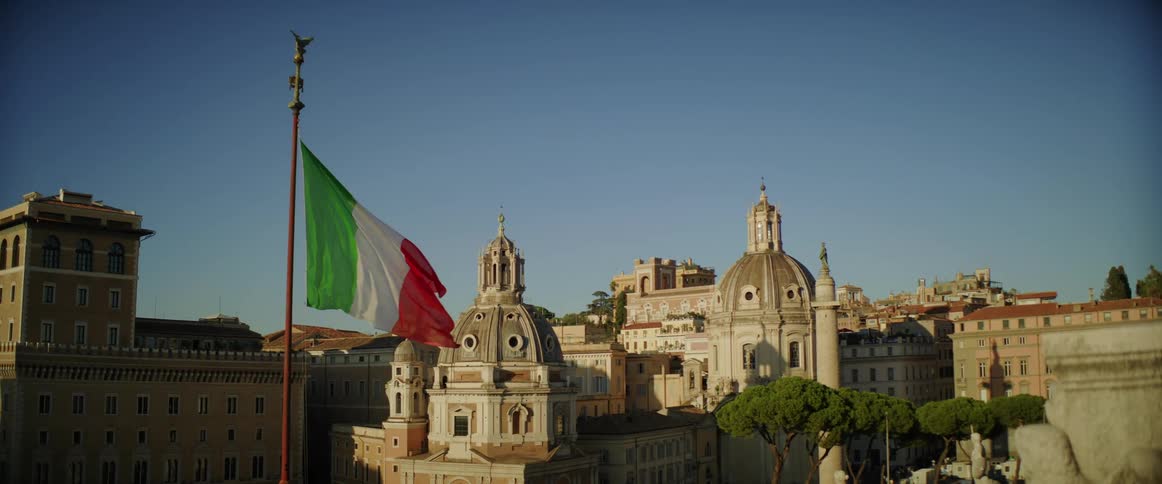 Italian flag waves in wind in city center