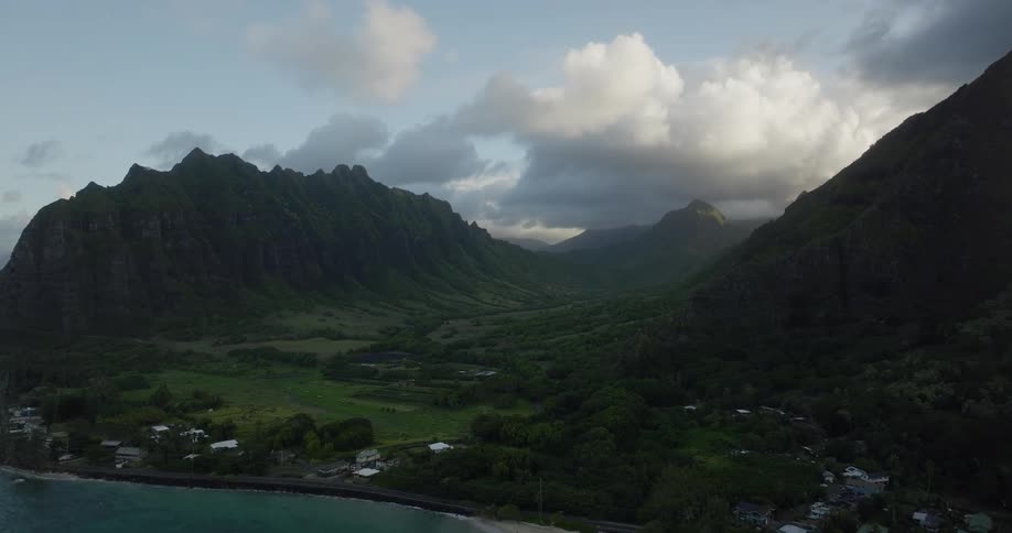 Aerial view of coastal town and valley between high mountains