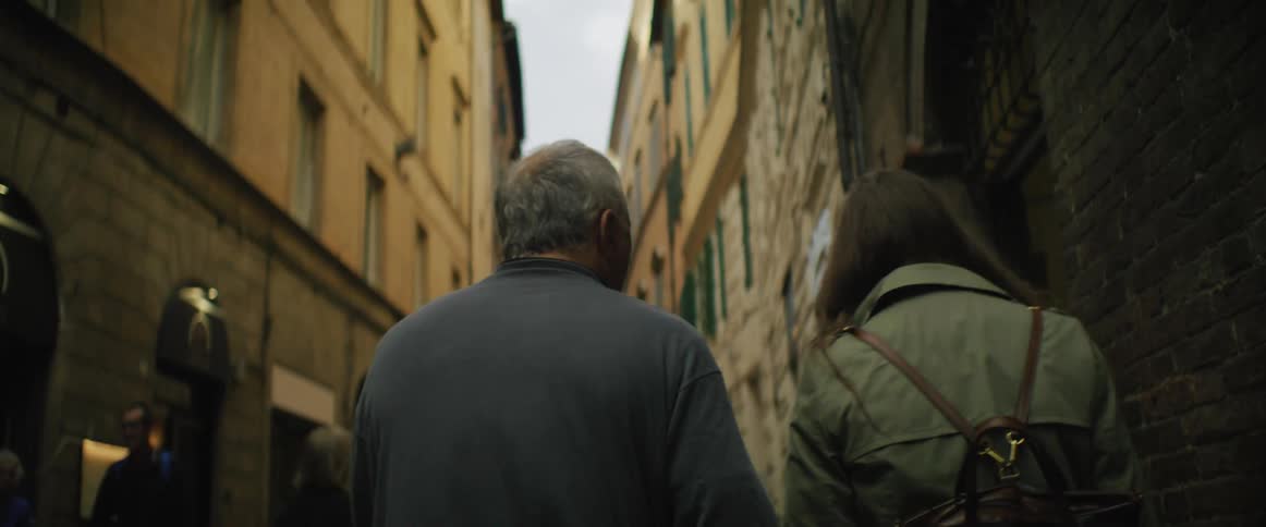 A man and woman walking outdoors