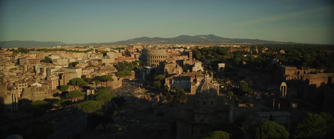 An ancient style stadium sits in the center of a historical city