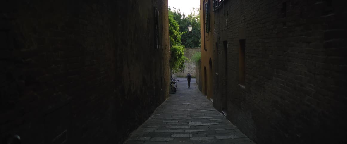 Man walks down alley in the city