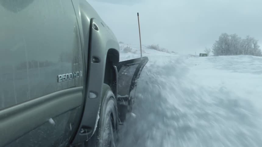 A truck plowing snow