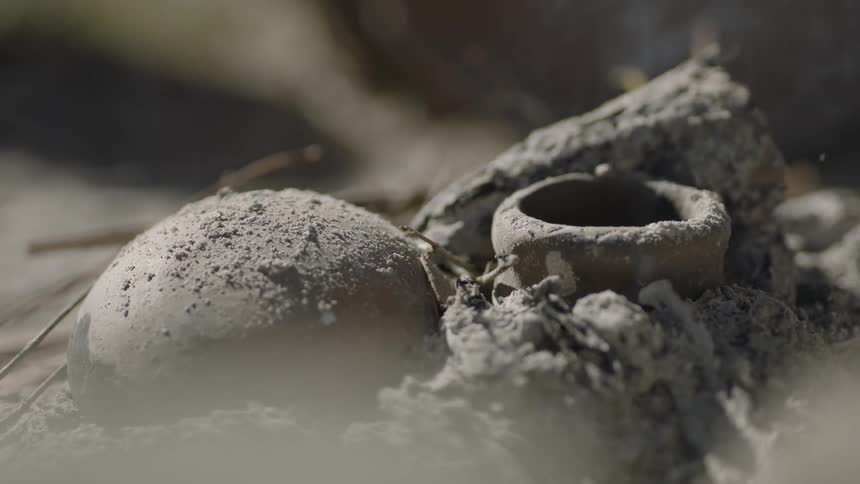 A pile of ashes smokes