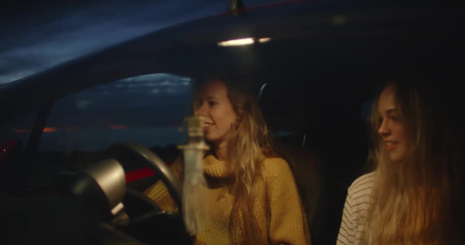 Two women sit in the car together