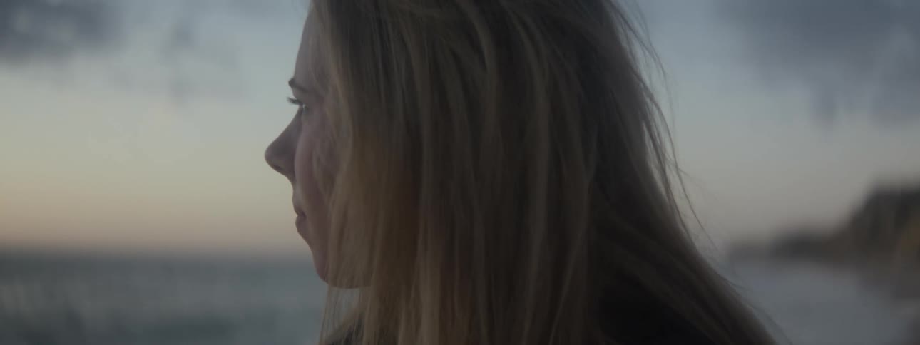 A woman looks around on the beach