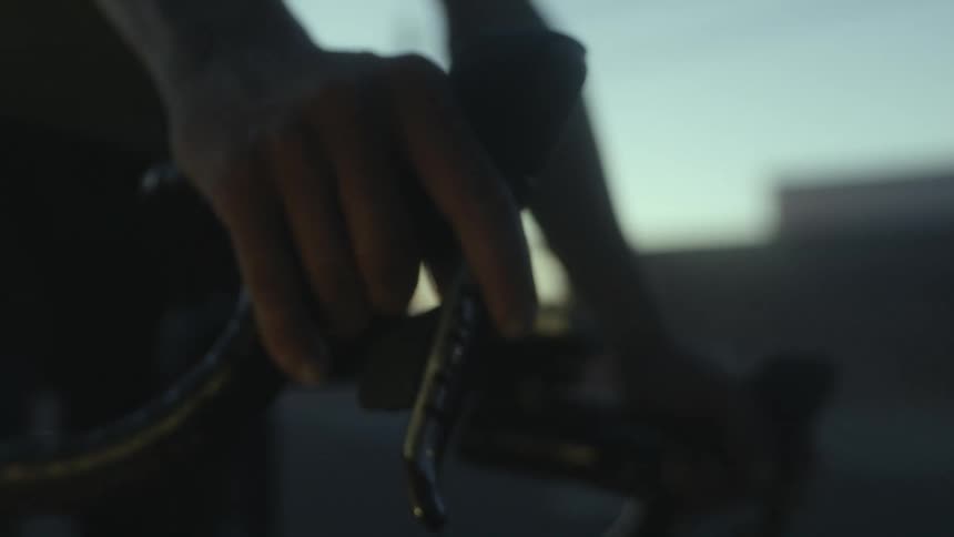 A person placing their hands on the handlebars of a bicycle