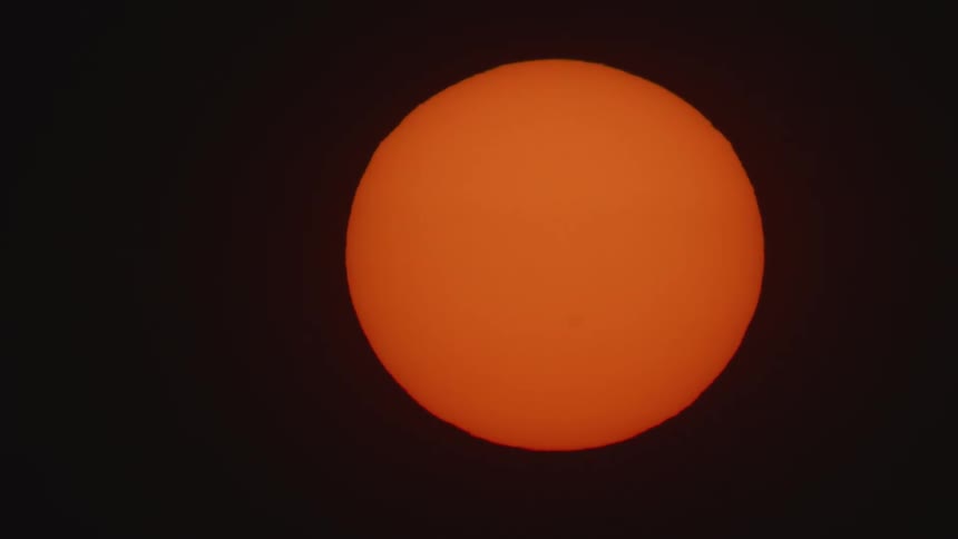 The sun is visible in the night sky
