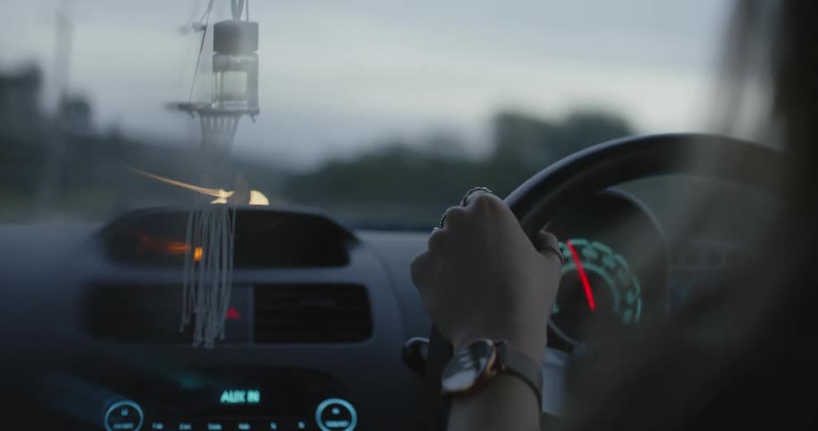 A woman is driving a car