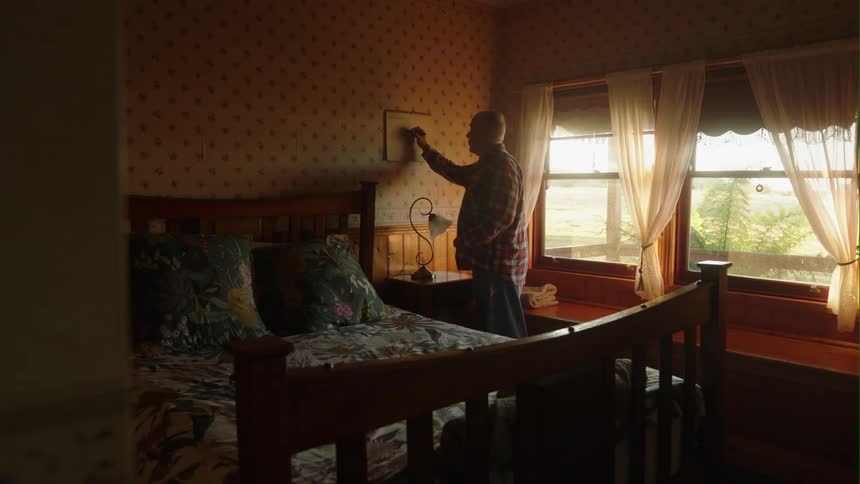 A man writing on a calendar in a room