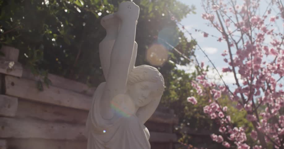 A statue in a park is displayed in spring